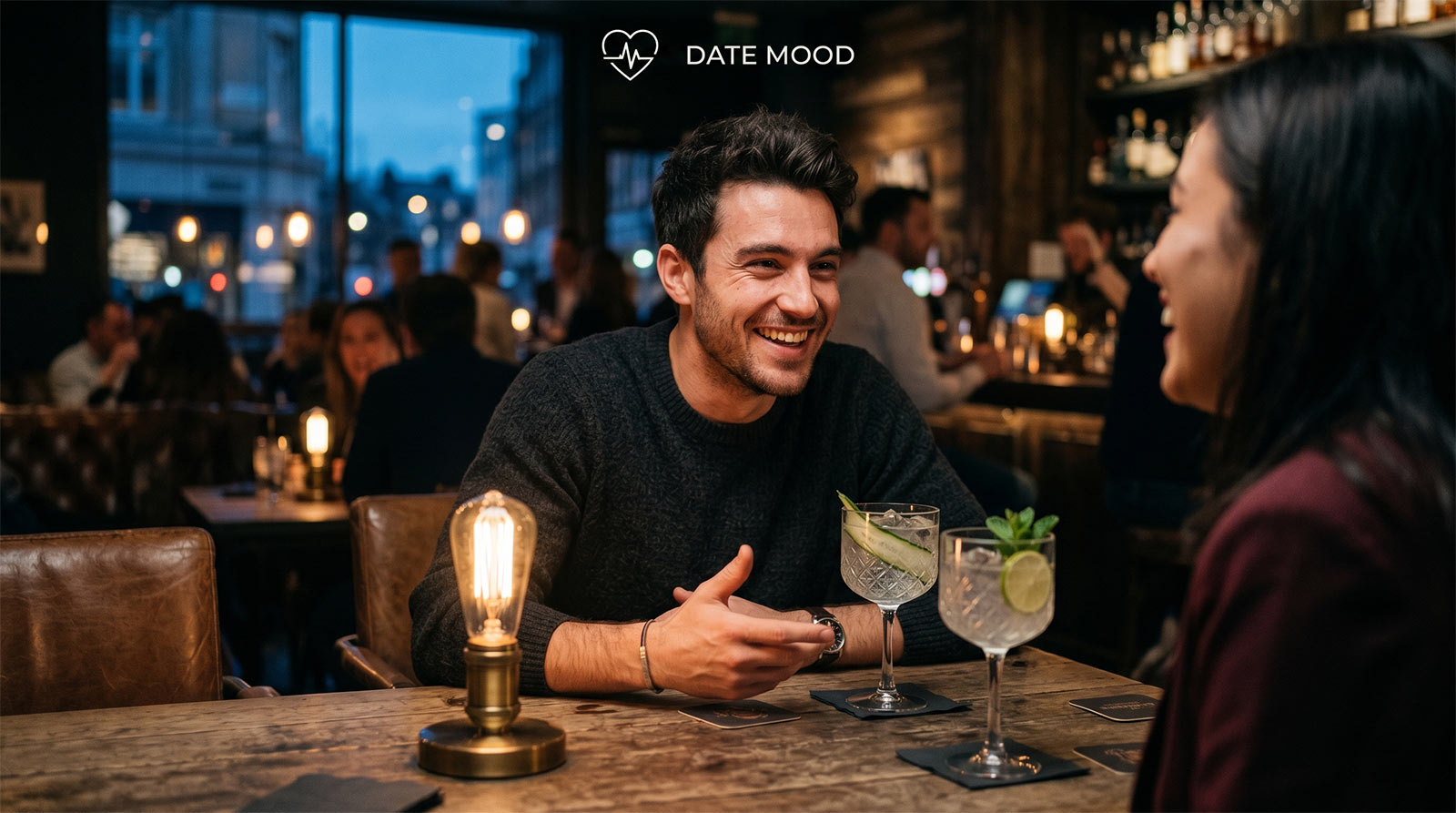 A close-up cinematic photo of a man laughing animatedly and leaning forward over a candlelit table, illustrating the moment a bold flirty question ignites genuine romantic tension.