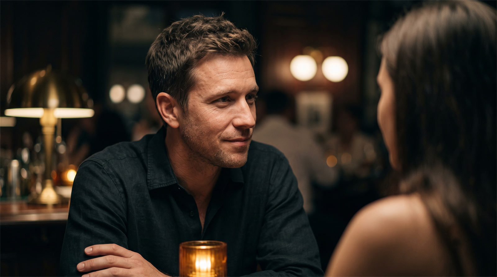 Close-up cinematic shot of a man looking with a quiet, confident smirk at a woman in a moody, dimly lit upscale bar, embodying the art of modern flirting and sexual tension.